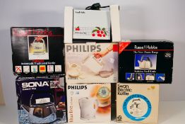 A collection of boxed household electrical items comprising six kettles and a toaster.