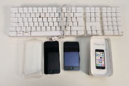A collection of Apple products, lot to include iPod, iPhone 5c and Apple keyboard.