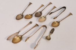 A collection of silver spoons and sugar tongs, approximately 97 grams / 3.1 ozt.