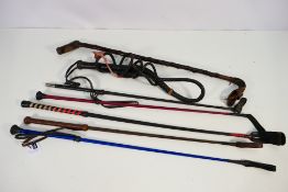 A collection of riding crops and similar.