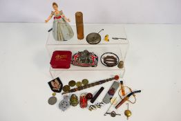 A mixed lot of small collectibles to include coins, enamel belt buckle,