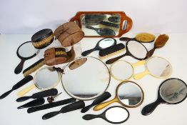 A collection of vintage mirrors and brushes.