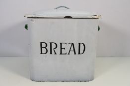 An enamel bread bin and cover, approximately 35 cm x 35 cm x 25 cm.