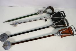 Four vintage shooting sticks.