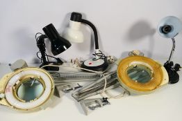 A collection of lamps to include two magnifying lamps.