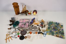 A mixed lot of small collectibles to include marbles and similar, small animal figures,