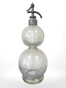 A double gourd-shaped glass and pewter seltzer bottle, height 50cm.