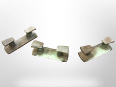 Three cast patinated brass dockside boat cleats, width 25cm.