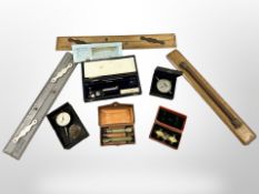A group of instruments including a rolling rule, fixed-arm planimeter,