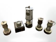 A Patterson miner's lamp, three similar lamps, and an Ever Ready torch, tallest 25cm.