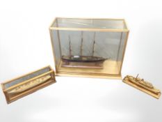 A scale model ship in glazed display case measuring 58cm by 24cm by 45cm,