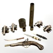 A group of four miniature metal desk cannons on wooden carriages, four inert brass shells,