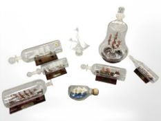 Seven glass ships in bottles and another similar model, including the Mary Rose, Santa Maria,