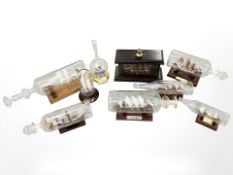 Eight glass ships in bottles and another similar model in wooden case, including the Santa Maria,