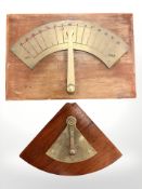 Two brass nautical inclinometers, each mounted on teak board, largest 52cm by 36cm.