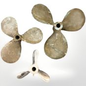 Two brass propellers and a small chrome example, largest 41cm diameter.