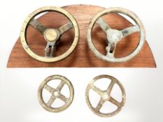 Two brass valve wheels mounted on a teak backing board measuring 60cm wide,