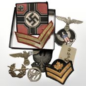 A group of reproduction badges and other military insignia