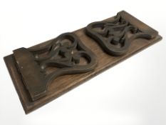 A carved oak book slide, length 32 cm.