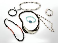 A polished wood and mother of pearl necklace,