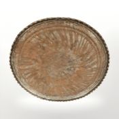 A large Eastern engraved metal charger, diameter 90 cm.