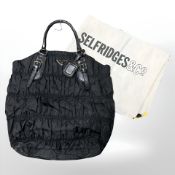 Prada: A black nylon Tessuto Gaufre tote bag, with authenticity card, numbered BN 1611,