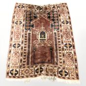 An Afghan prayer rug, 150 cm x 83 cm.