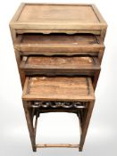 An early 20th century Chinese carved hardwood nest of four tables,
