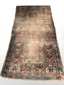 An antique Feraghan rug, West Iran, 256 cm x 127 cm CONDITION REPORT: Heavily worn,