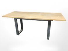 An industrial style pine topped refectory table on metal support, 180 cm x 71 cm x 75 cm.