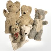 A group of vintage teddy bears and hand puppets.