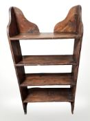 A late Victorian stained pine open bookshelf,