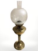 A brass oil lamp with etched glass shade, height 63 cm.
