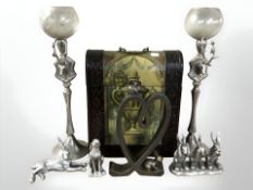 A pair of decorative silver plated candle holders decorated with stags, further rabbit ornaments,
