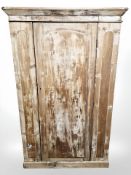 A Victorian scumbled pine single door wardrobe,