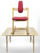 A contemporary beech table on splayed legs and Stokke rocking chair