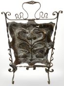 An Art Nouveau hammered copper and wrought iron fire screen, height 81 cm.