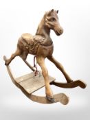 A 20th century carved pine rocking horse,