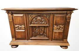 A 20th century continental carved and panelled oak cabinet on bulbous feet, 192 cm x 54 cm x 126 cm.