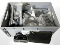 A quantity of new lady's black leather hand bags with retail tags.