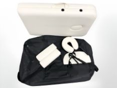 A folding cream vinyl massage table.