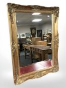 A reproduction gilt bevelled mirror,