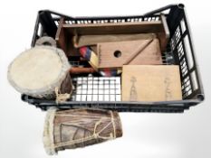 Two African hide coloured drums, a stringed instrument, book trough,