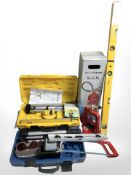A group of hand tools, boxed fire extinguisher, spirit levels.
