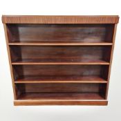 A 20th century continental walnut open bookcase, 149 cm x 25 cm x 136 cm.