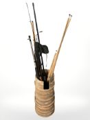 A wooden bound barrel containing billiard cues,