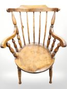 An elm spindle back armchair.