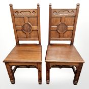 A pair of panelled oak ecclesiastical chairs
