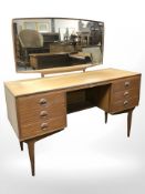 A 20th century teak mirror backed dressing table,