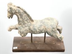 An ornamental pottery horse figure on plinth,